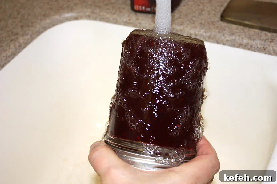Homemade Cranberry Sauce: Jellied or Whole-Berry Recipe 3 Mason jar upside down under running water.