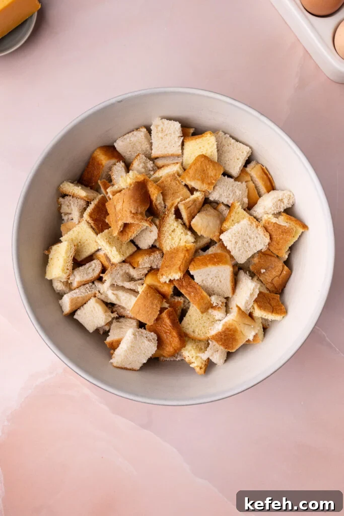 Savory Chive French Toast Casserole Recipe for Brunch 6 Cubed bread in a large bowl.