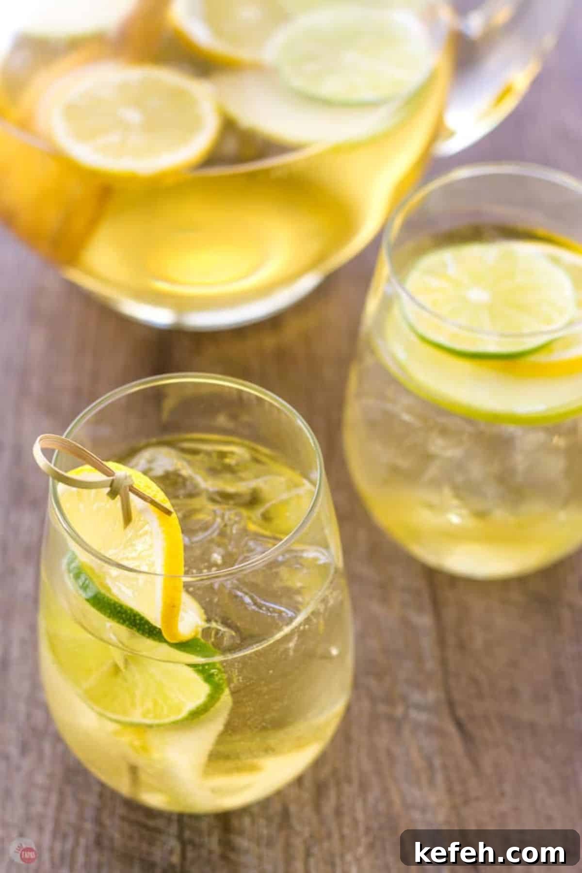 Refreshing Summer Sangria Recipe with Fresh Fruit 4 Two glasses of sangria with slices of lime.
