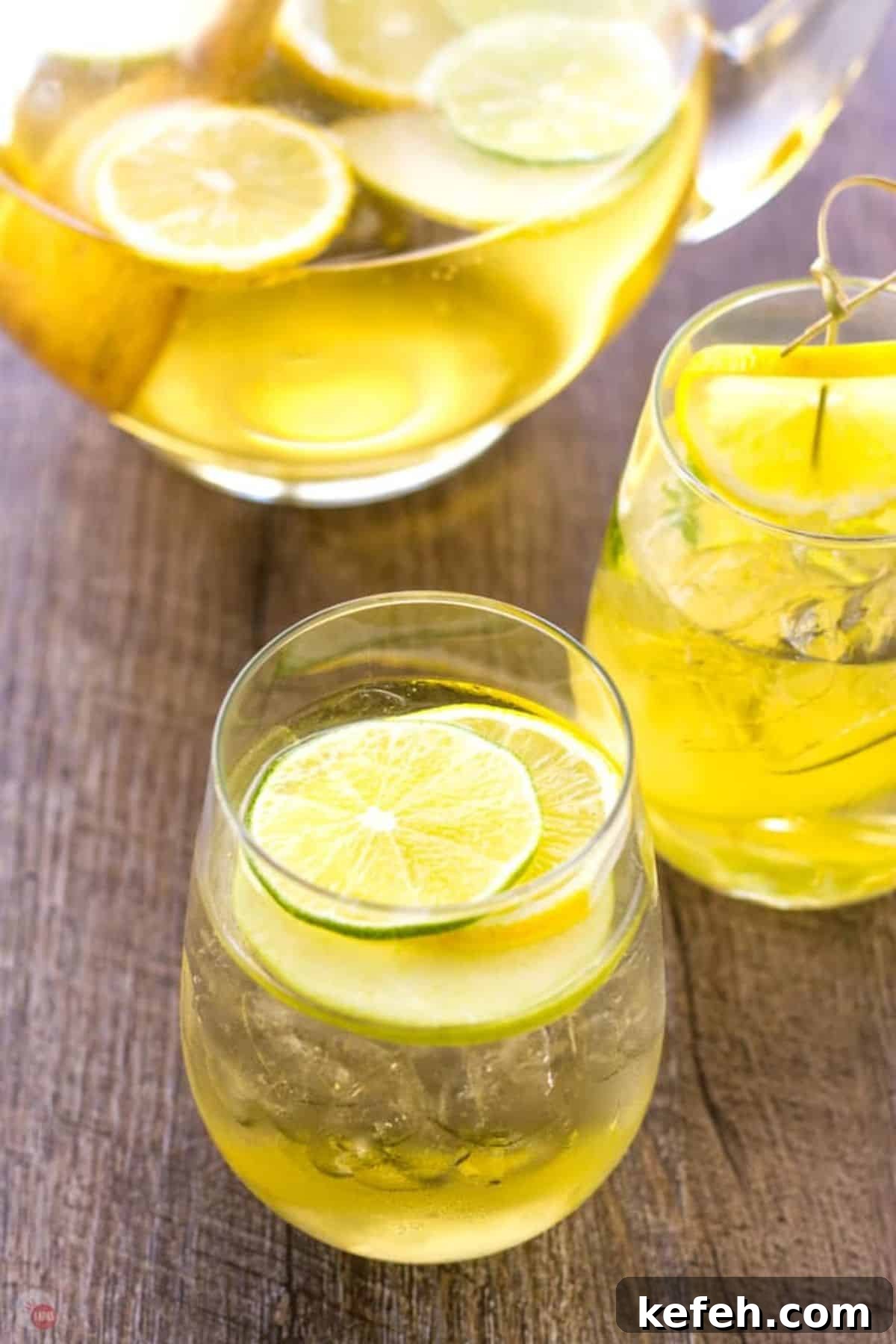 Refreshing Summer Sangria Recipe with Fresh Fruit 6 A pitcher of sangria with slices of lemon and a glass of wine.