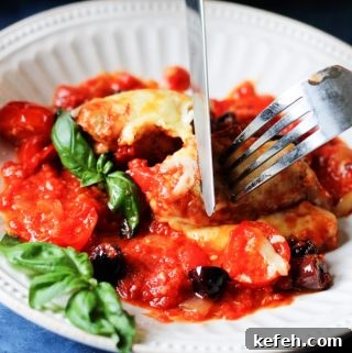 Veal Rollatini with Peppers, Cheese & Basil in Tomato-Olive Sauce 15 Veal Rollatini on a plate with fork and knife
