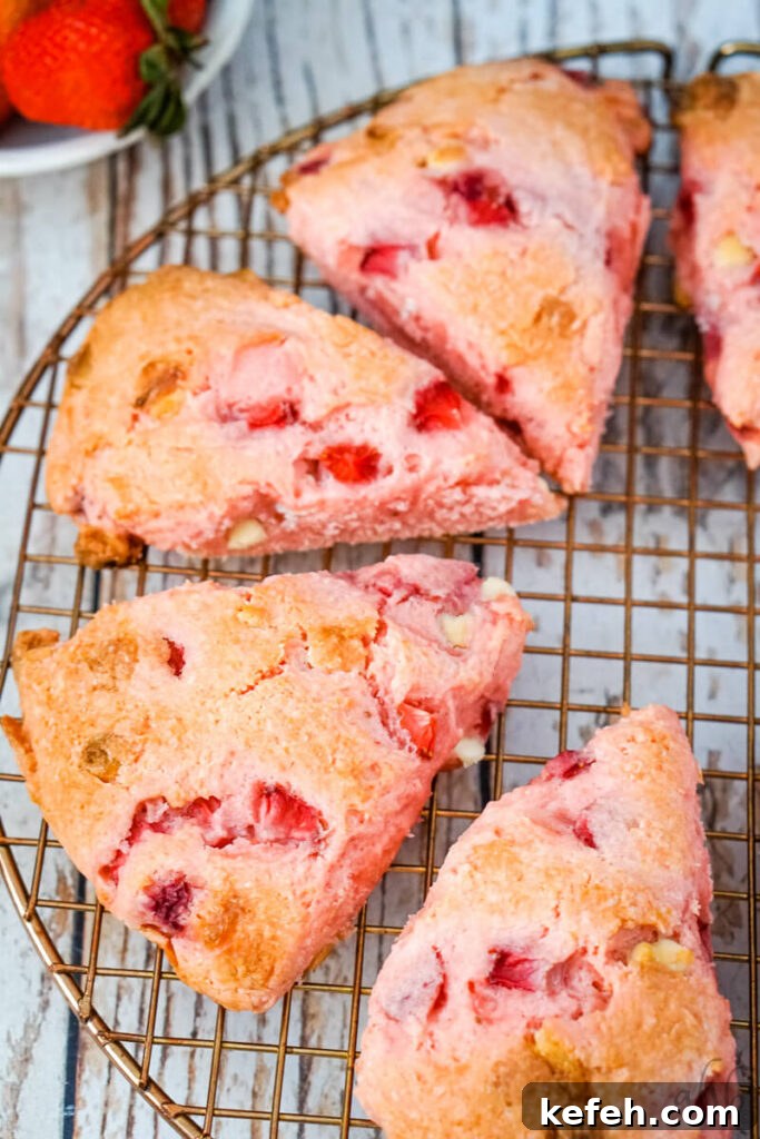 Strawberry cake mix scones cooling on a wire rack. 
