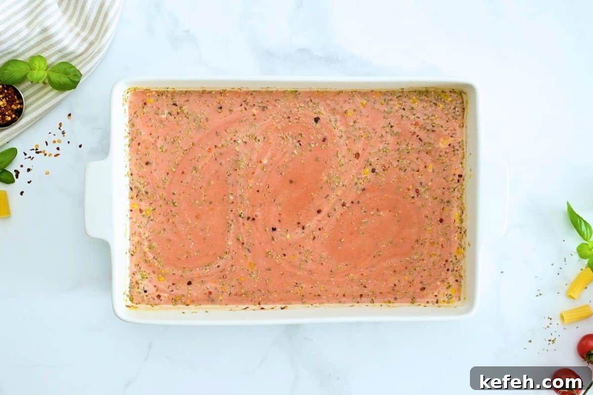 Pasta Bake No Boil Spaghetti sauce, heavy cream and seasonings whisked together in white casserole dish to create pasta bake sauce.