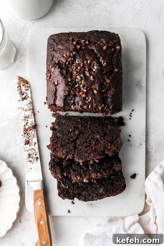Fudgy Chocolate Banana Bread Recipe 2 sliced chocolate banana bread with mini chocolate chips on top