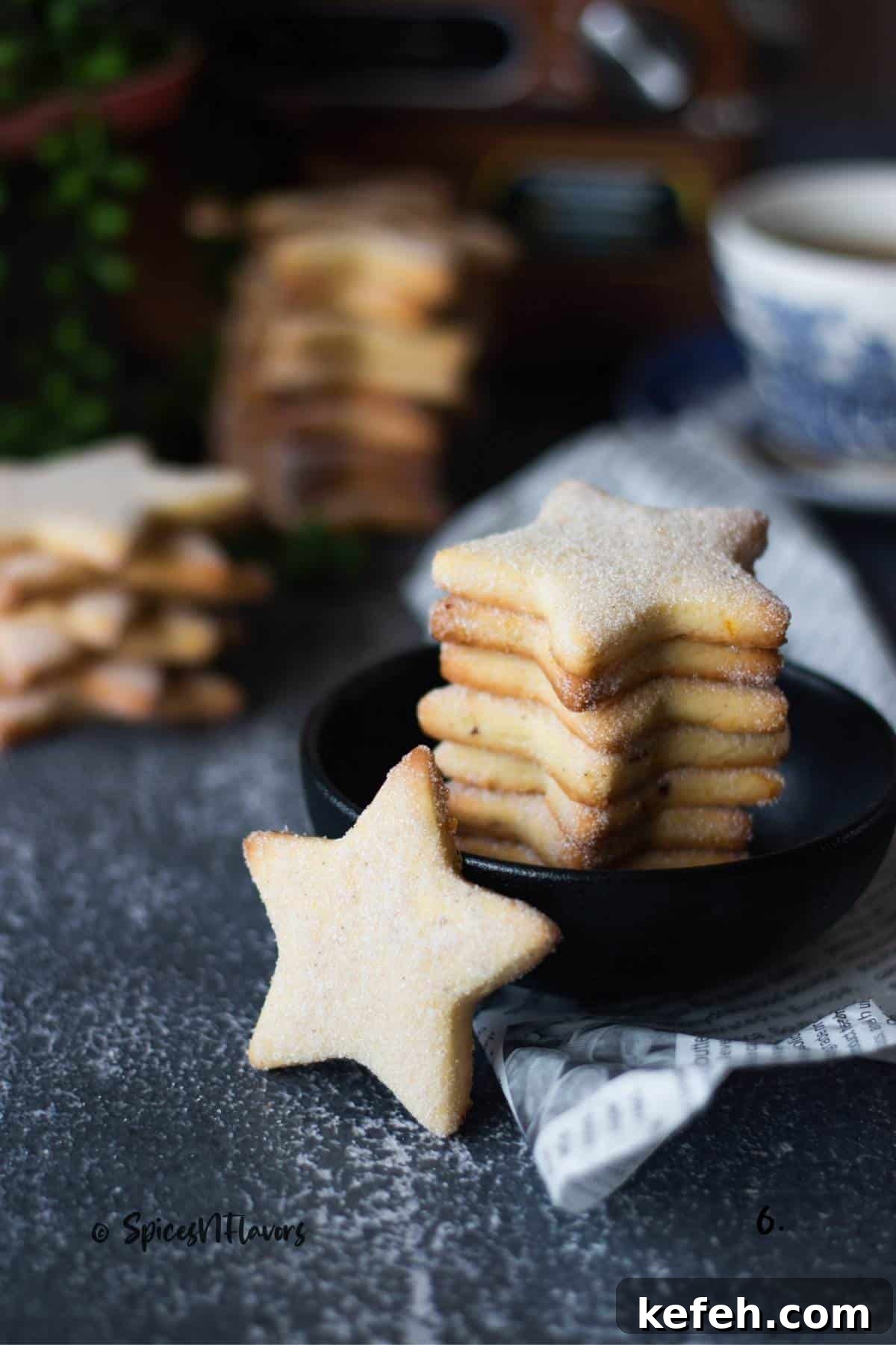 Biscochitos Recipe Without Lard — New Mexico’s Traditional Cookies 12 star shaped cookie placed in the front with other being placed in a black bowl