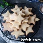 Biscochitos Recipe Without Lard — New Mexico’s Traditional Cookies 14 close up image of star cookies arranged on a wire rack to fit the recipe card image