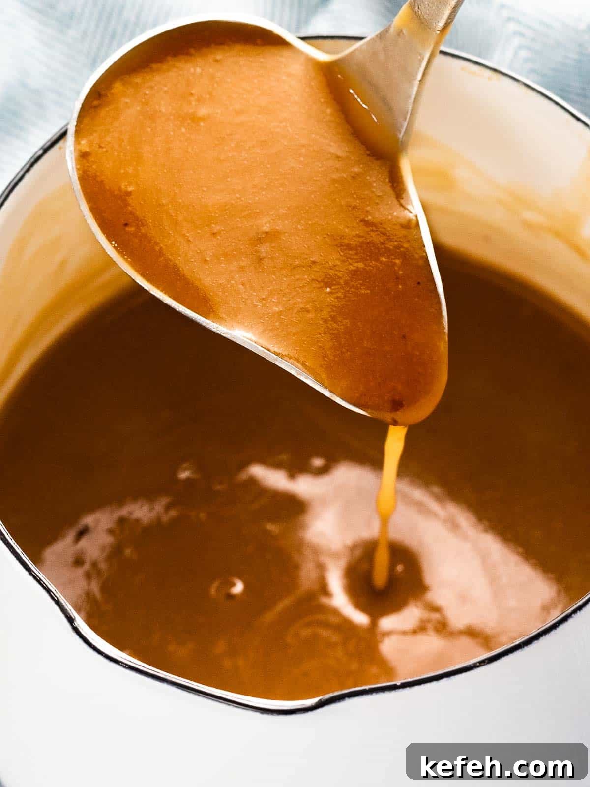Homemade Brown Gravy Without Drippings: Simple Stove-Top Recipe 2 Easy homemade brown gravy recipe poured from a ladle.