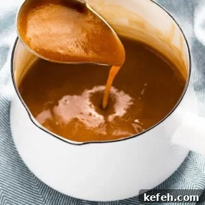 Homemade Brown Gravy Without Drippings: Simple Stove-Top Recipe 6 Brown gravy made with beef stock poured from ladle.