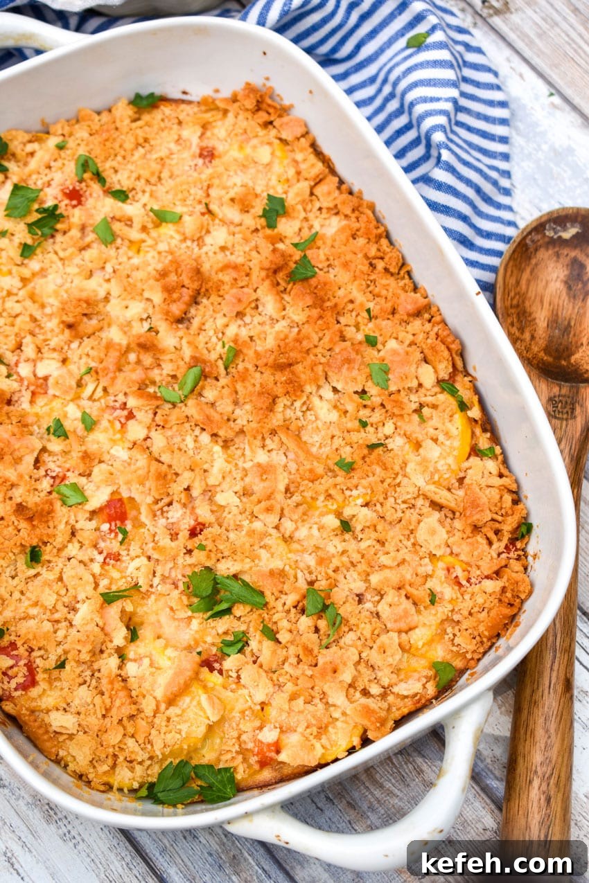 Classic Southern Squash Casserole Recipe for Comforting Dinners 3 southern squash casserole in a white baking dish with pieces of fresh parsley leaves on top