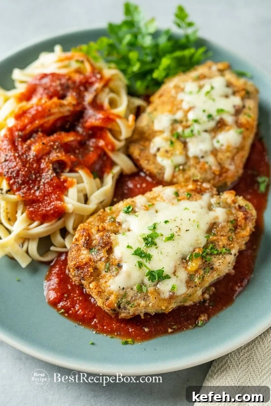Air Fryer Italian Pork Chop Parmesan Recipe is an Easy Crusted Pork Parmesan @BestRecipeBox Air Fryer Italian Pork Chop Parmesan Recipe on a plate
