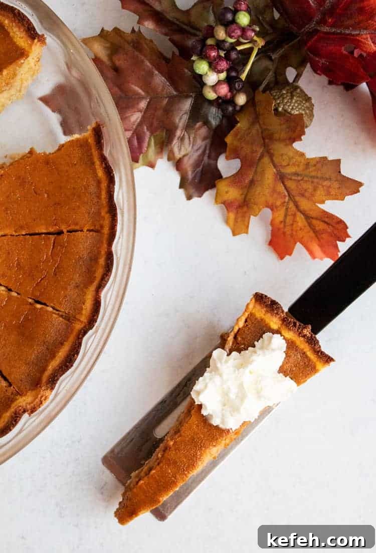 thin slice of keto pumpkin pie next to fall foliage