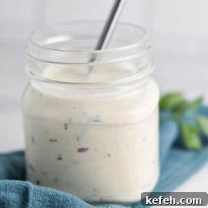 Creamy Homemade Gluten-Free Ranch Dressing Recipe 9 A jar of gluten free ranch dressing with a whisk.