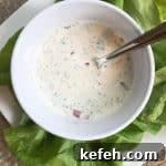 Creamy Homemade Gluten-Free Ranch Dressing Recipe 10 A white bowl with ranch dip and a spoon.