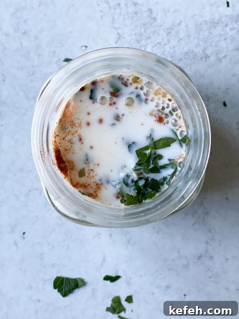 Creamy Homemade Gluten-Free Ranch Dressing Recipe 5 Spices and herbs being mixed in a mason jar.