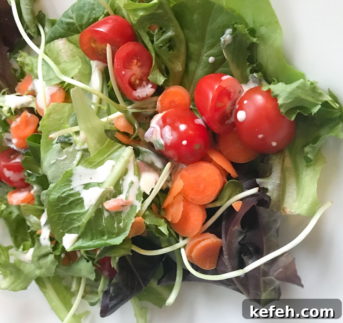 Creamy Homemade Gluten-Free Ranch Dressing Recipe 8 A green salad tossed in ranch dressing.