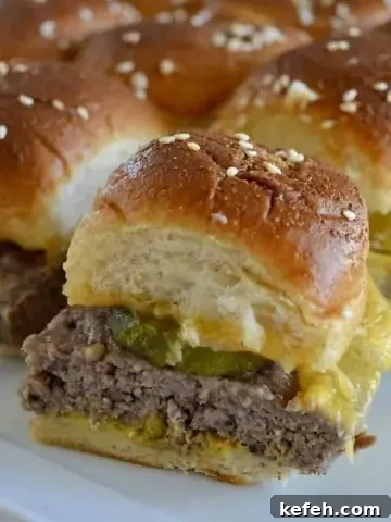Easy baked cheeseburger sliders on a white plate.