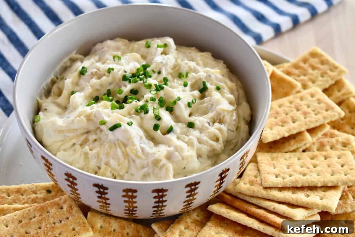 Caramelized Onion Dip Made with Greek Yogurt — Savory Party Dip 3 Caramelized Onion Dip with Greek Yogurt in a bowl with crackers next to it.