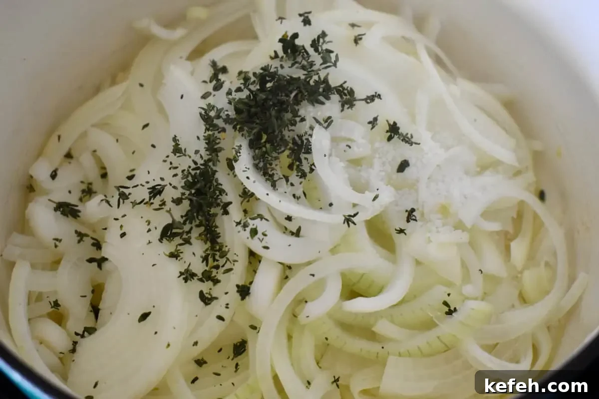 Caramelized Onion Dip Made with Greek Yogurt — Savory Party Dip 5 Sliced onions in a dutch oven with thyme and kosher salt.