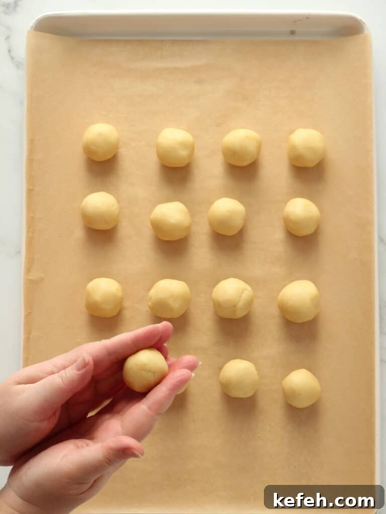 Rolling cookie dough in balls.