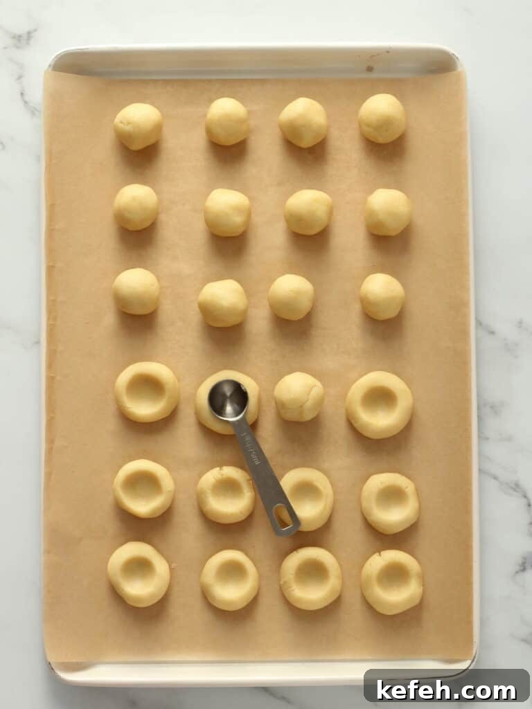 Making little wells in cookie dough.