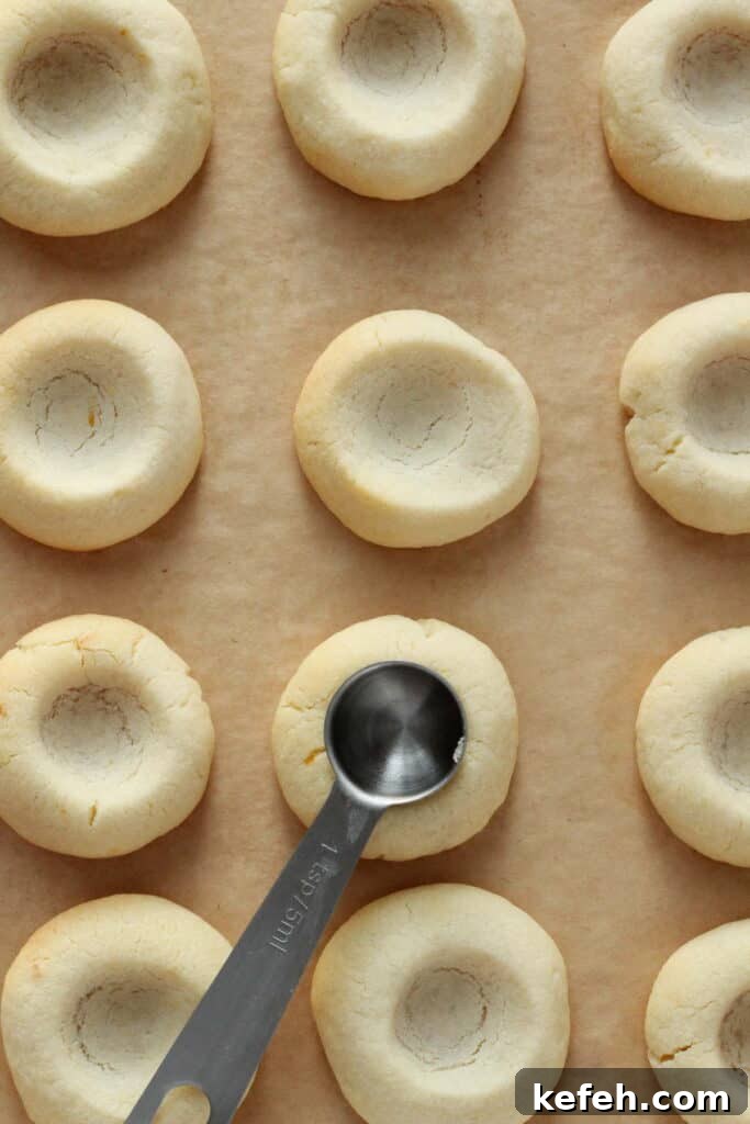 Making little wells in cookie dough already bakes, for lemon curd.