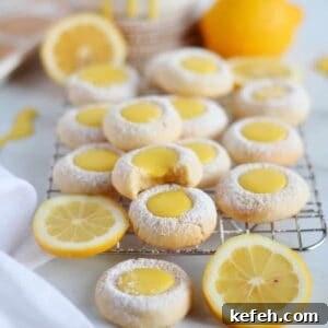 Thumbprint cookies filled with lemon curd placed on cooling rack.