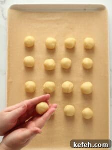 Rolling cookie dough in balls.