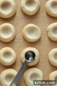 Making little wells in cookie dough already bakes, for lemon curd.