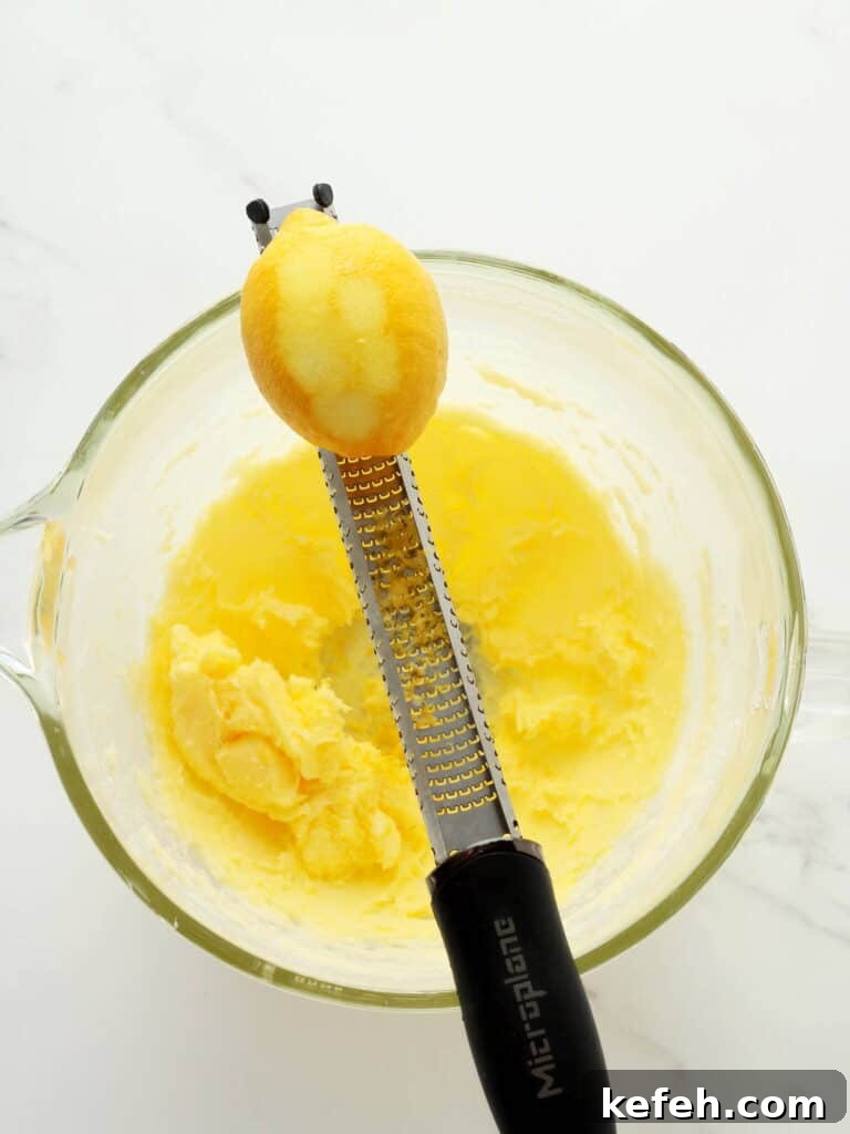 Zesting lemon in lemon cookie batter.