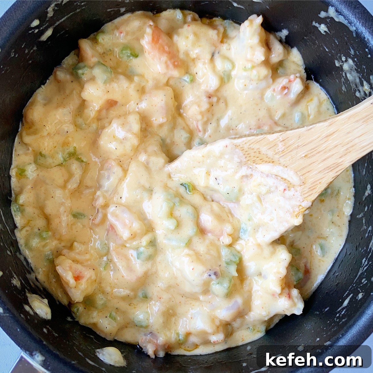 cooked cream sauce with shrimp in a saucepan