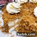 Sliced Lotus Biscoff cake on a cake board.
