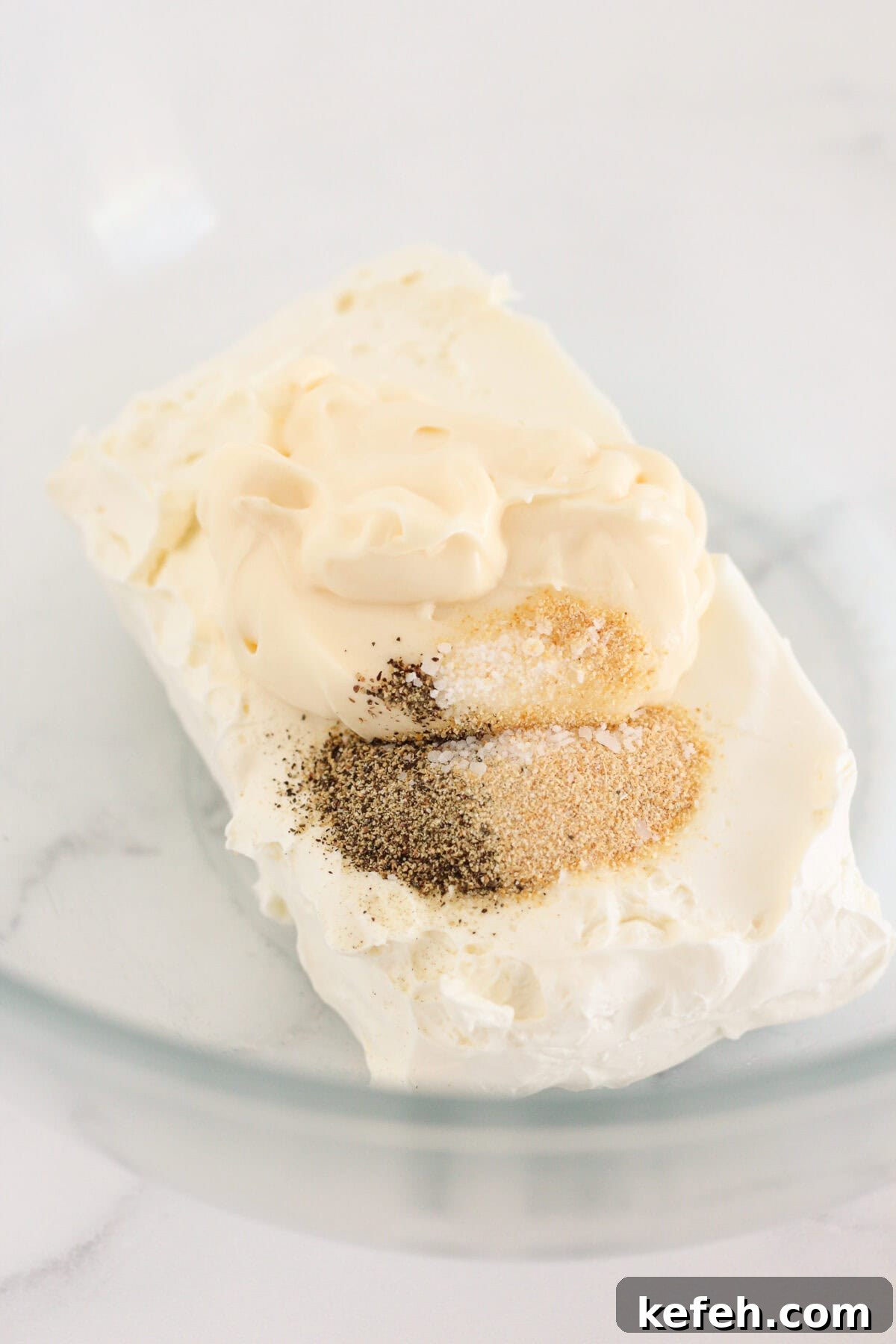 Combining the cream cheese and spices in a medium bowl.
