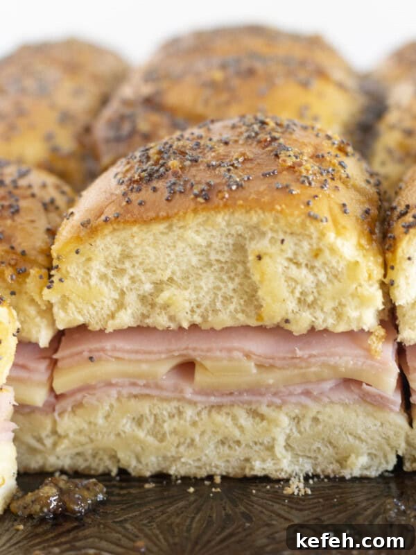 Serving brown sugar and ham sliders on a tray.