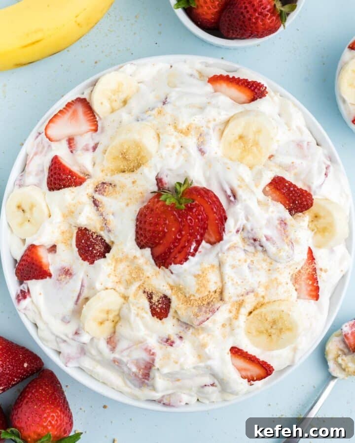 Strawberry banana cheesecake salad in a bowl on the table.