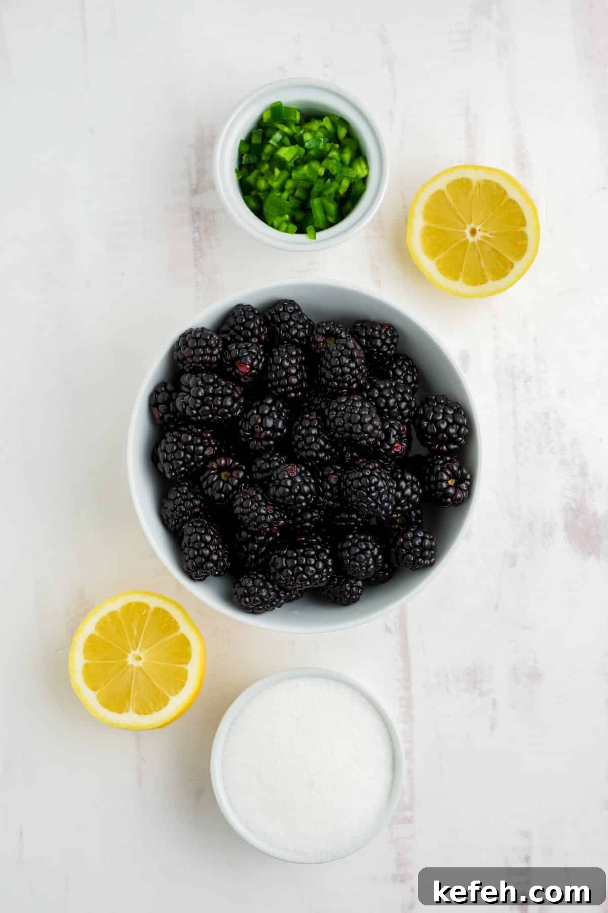 Spicy Blackberry Jalapeño Jam Recipe for Preserving and Gifts 3 Bowls of ingredients to make blackberry and jalapeno jam on the table before cooking.