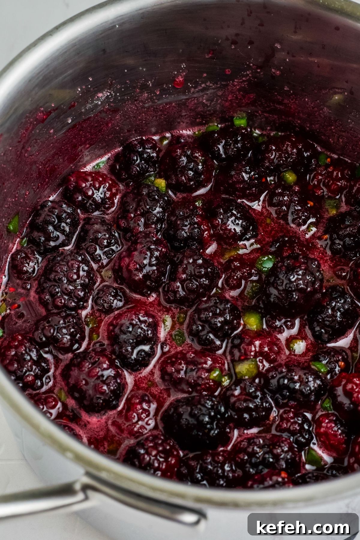 Spicy Blackberry Jalapeño Jam Recipe for Preserving and Gifts 5 Blackberries after cooking a bit with the jalapenos and sugar.