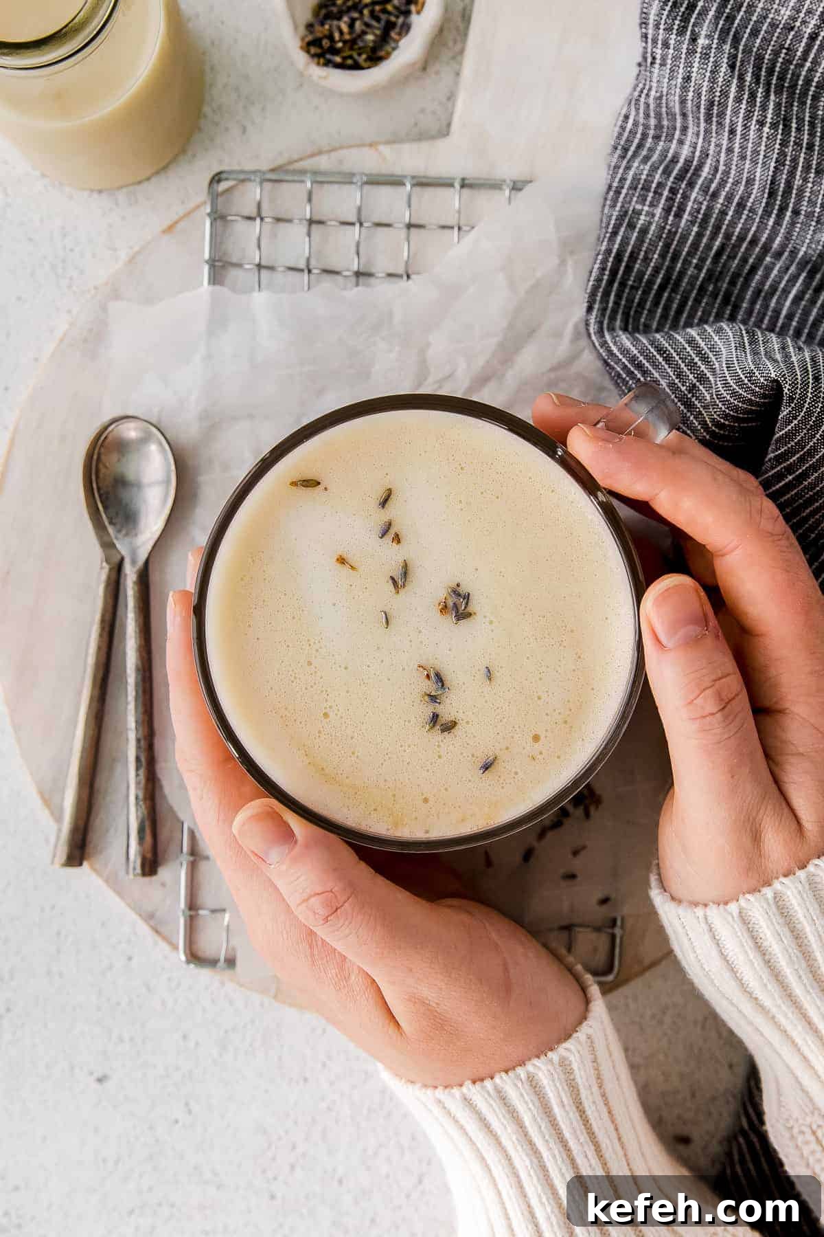 london fog drink in a mug with hands holding it