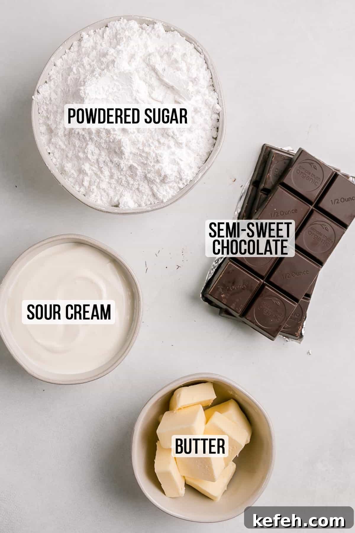 Ingredients for chocolate sour cream frosting measured out in bowls.
