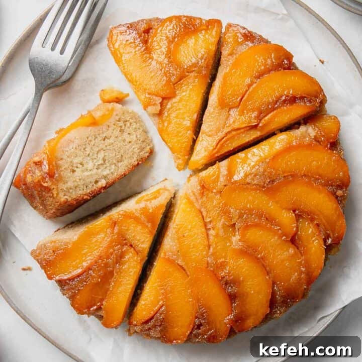 A round gluten-free peach upside down cake with peaches on top.