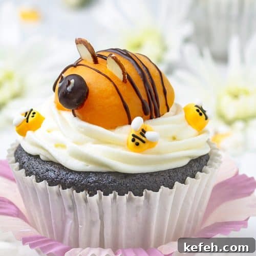 Bumblebee Chocolate Cupcakes with Cream Cheese Swirl Frosting 4 Adorable apricot bee sitting on top of cream cheese frosted chocolate cupcake.
