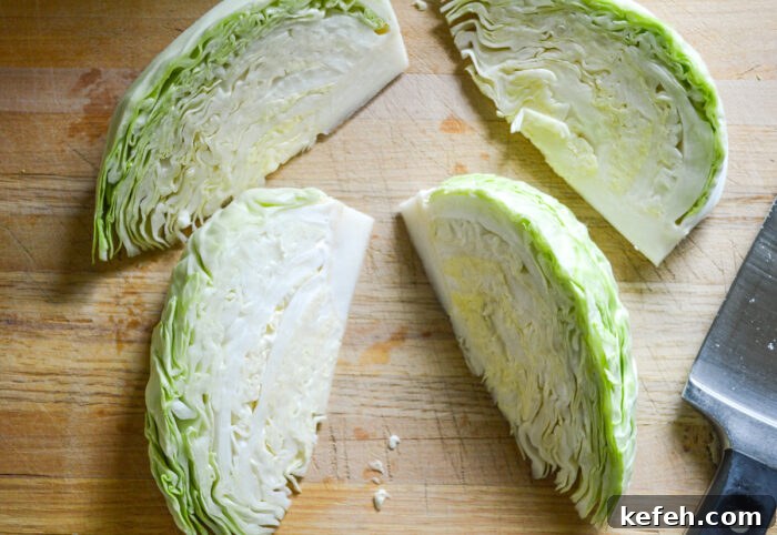 cabbage cut in wedges on cutting board