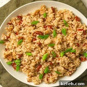 Instant Pot Jamaican Rice and Peas Recipe: Quick Authentic Flavor 12 A white plate filled with kidney beans and rice.