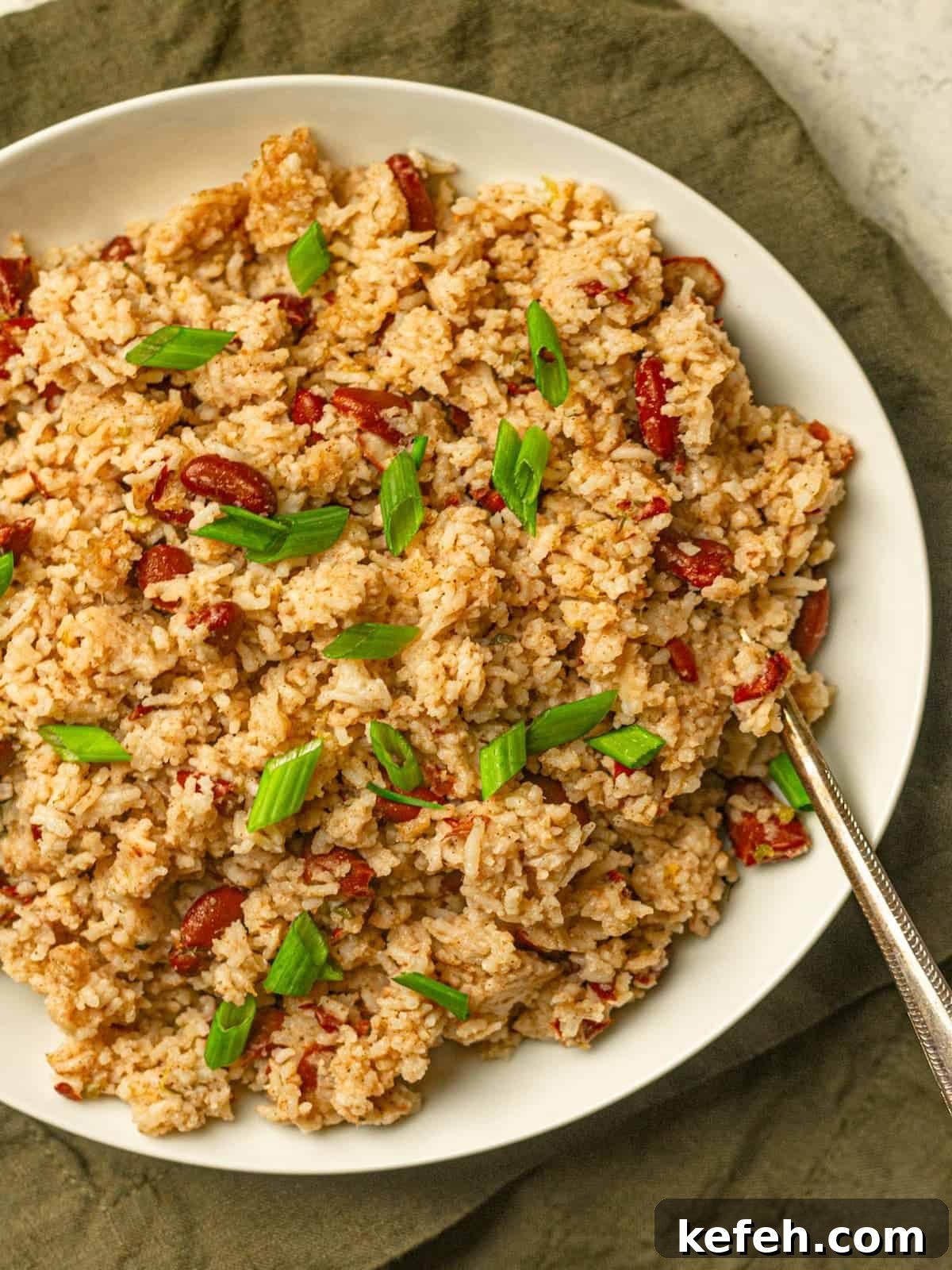Instant Pot Jamaican Rice and Peas Recipe: Quick Authentic Flavor 7 A plate of rice and kidney beans topped with green onions.