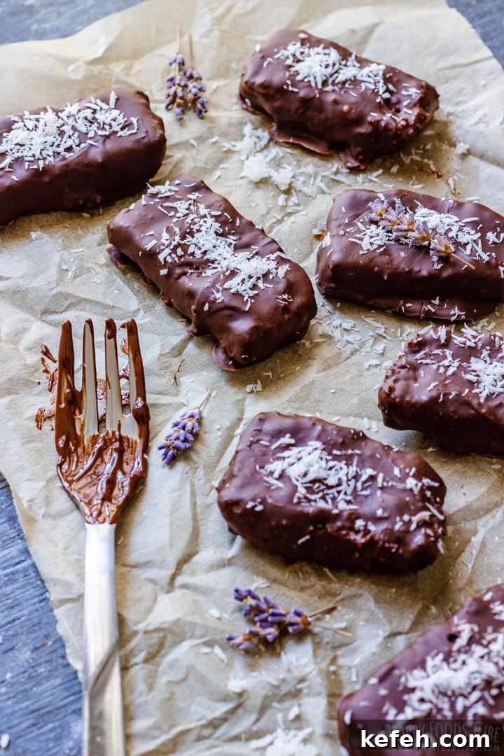 Coconut bars covered with chocolate ant topped with coconut shavings
