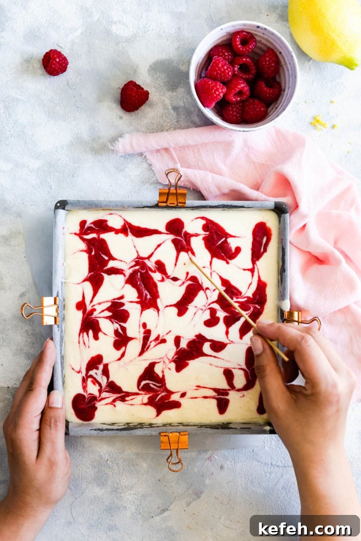 top view of a person creating swirls in cheesecake batter