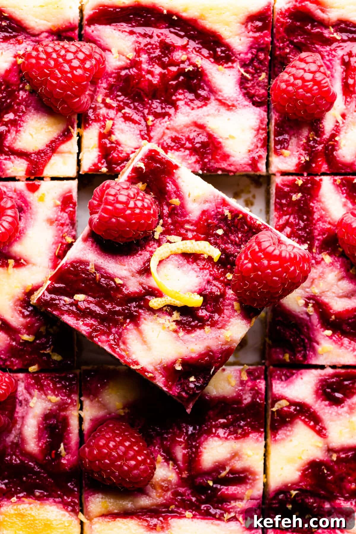top down super close up at a square slice of raspberry lemon cheesecake bar