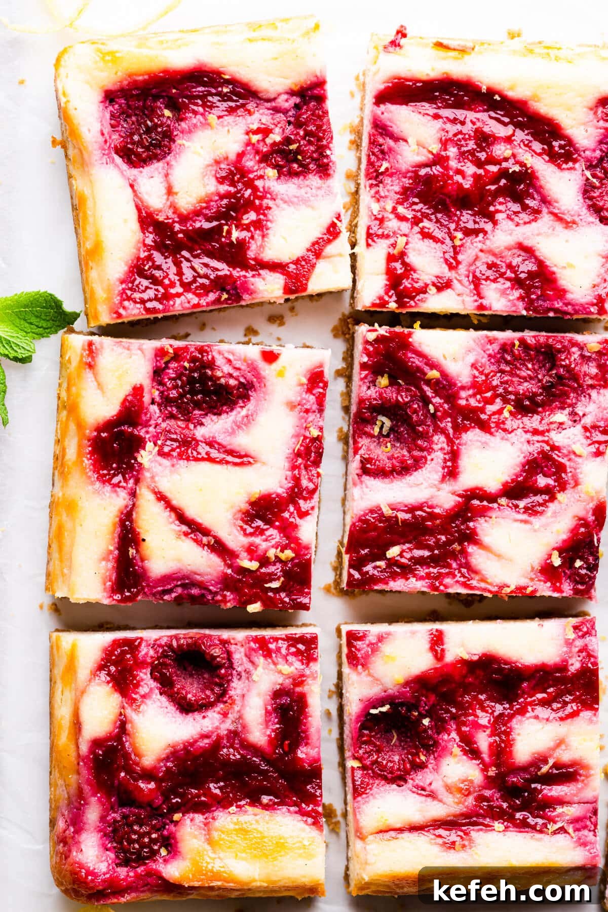 top down super close up of cheesecake bars with raspberry swirls