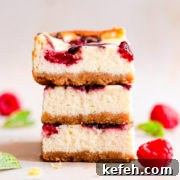 straight ahead close up of stack of three raspberry cheesecake bars