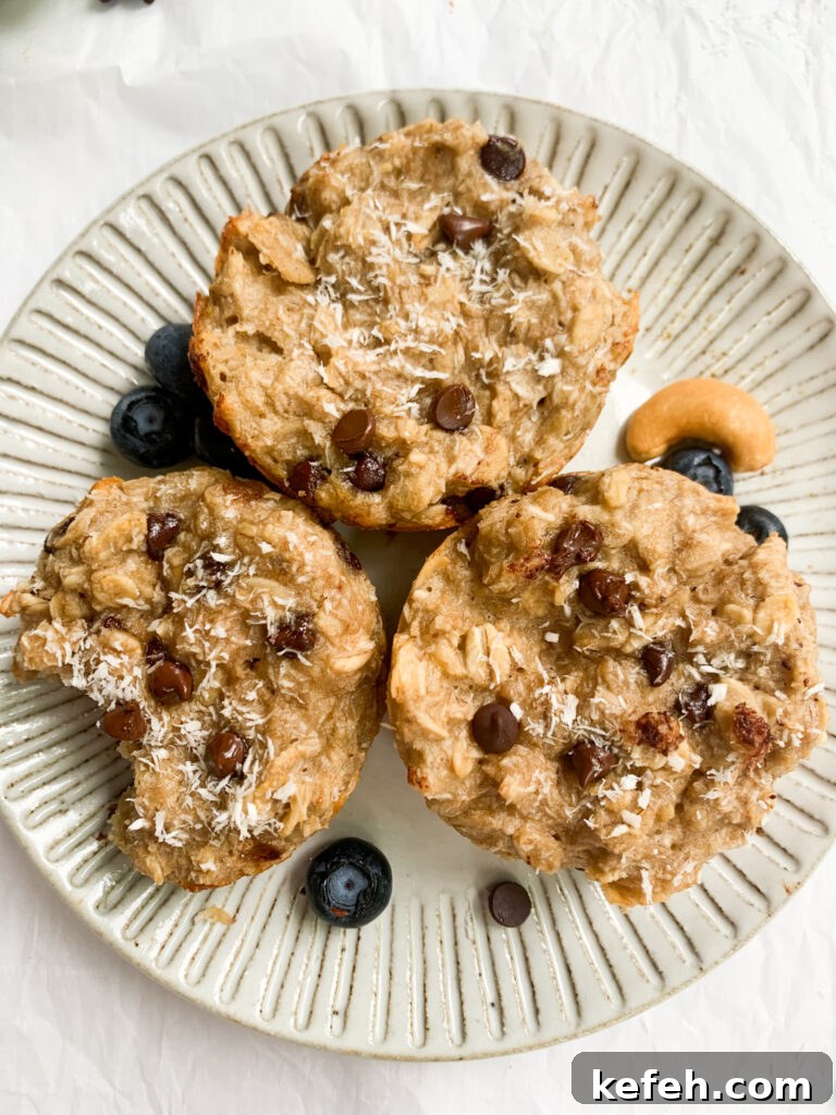 Coconut Cashew Oatmeal Breakfast Cups 2 a plate with three oatmeal cups, blueberries, and cashews