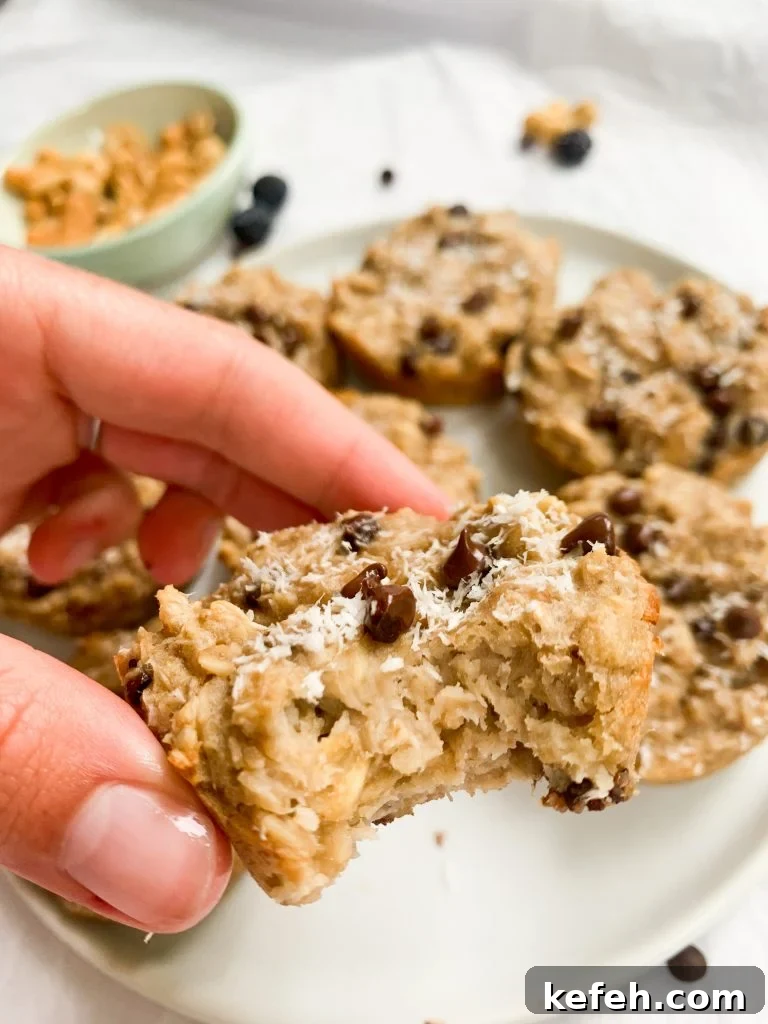 Coconut Cashew Oatmeal Breakfast Cups 5 a hand holding one of the oatmeal cups